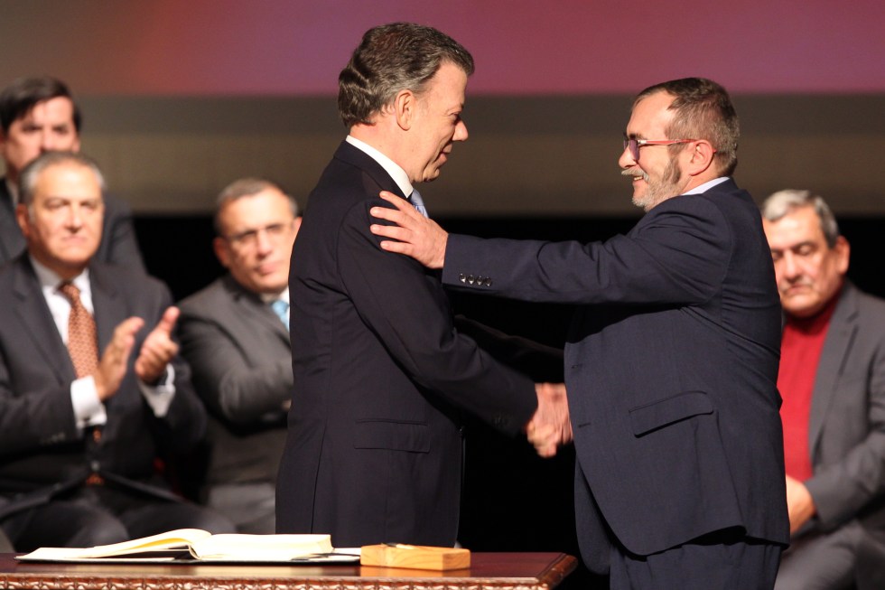 Fotografía de archivo del 24 de noviembre del 2016 que muestra al entonces presidente de Colombia, Juan Manuel Santos (i), y el jefe máximo de las FARC, Rodrigo Londoño Echeverry, al firmar el acuerdo de paz en el Teatro Colón. EFE/ Mauricio Dueñas Castañeda