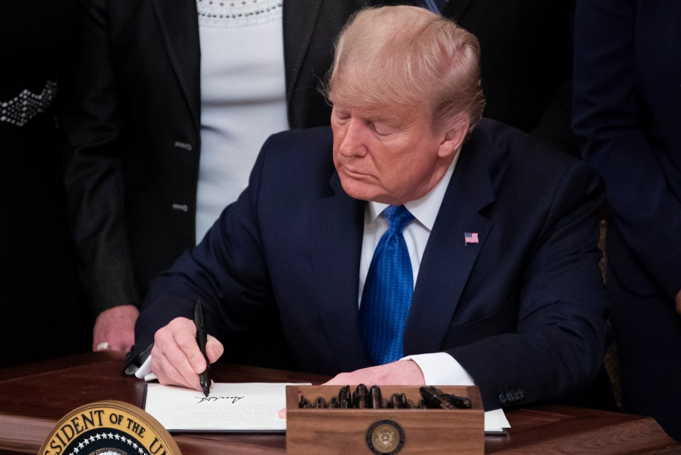 El expresidente de EE.UU., Donald Trump, firma un documento en la Casa Blanca, en una fotografía de archivo. EFE/Michael Reynolds