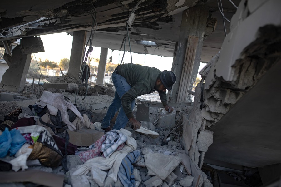 Los palestinos inspeccionan el lugar de un ataque aéreo israelí en el campamento de Khan Yunis