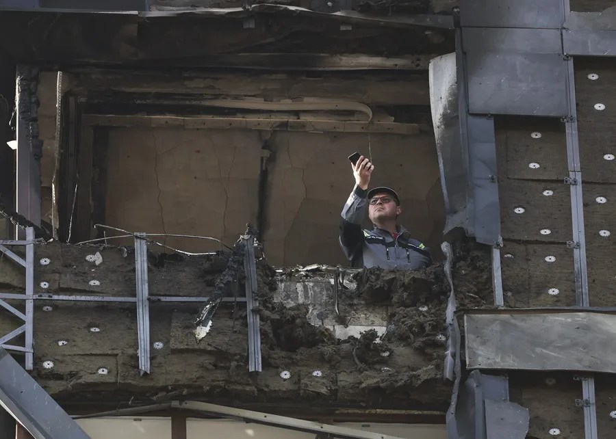rusia-2-1 Una persona observa desde un edificio de apartamentos dañado tras un ataque con un dron ucraniano en Krasnogorsk